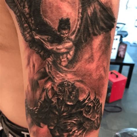 angel and devil fighting tattoos|angel stepping on demon tattoo.